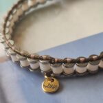 bransoletka z masy perłowej i hematytu. utkana na krośnie. -logo e stali w kolorze złotym