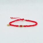 Bransoletka makrama w kolorze czerwonym z ozdobnymi złotymi koralikami i kamieniem koral- handmade biżuteria My DNA