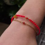 Bransoletka makrama w kolorze czerwonym z ozdobnymi złotymi koralikami i kamieniem koral- handmade biżuteria My DNA